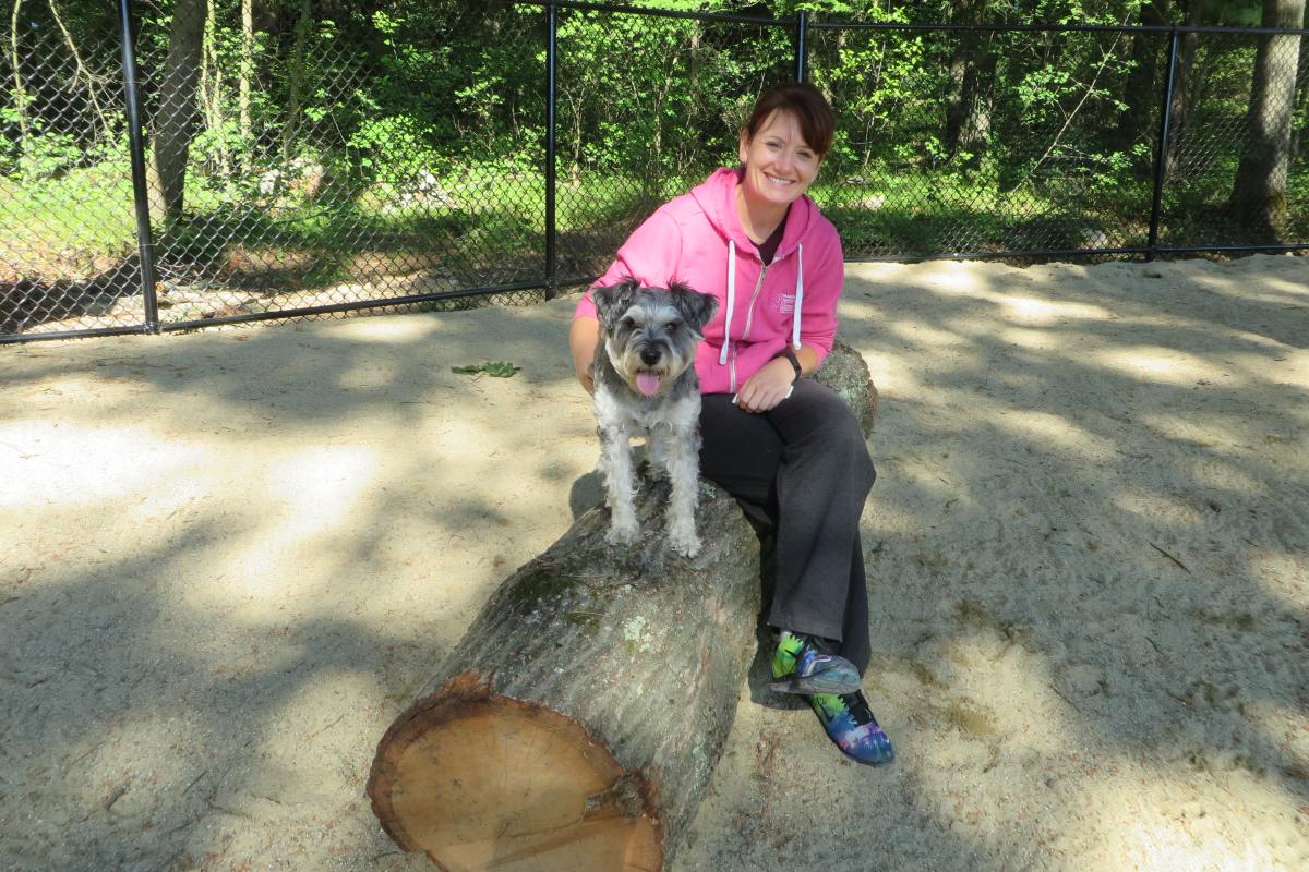 girl and dog on log